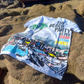 Colorful beach-themed face mask on a rocky surface
